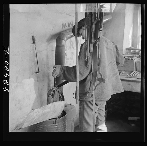 Untitled photo, possibly related to: Honey Brook, Pennsylvania (vicinity). Amish farmland dipping harness in oil on the Zook farm