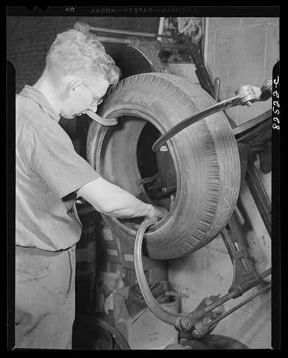 Washington, D.C. Washington tire store. Mending a tear in the lining of a tire