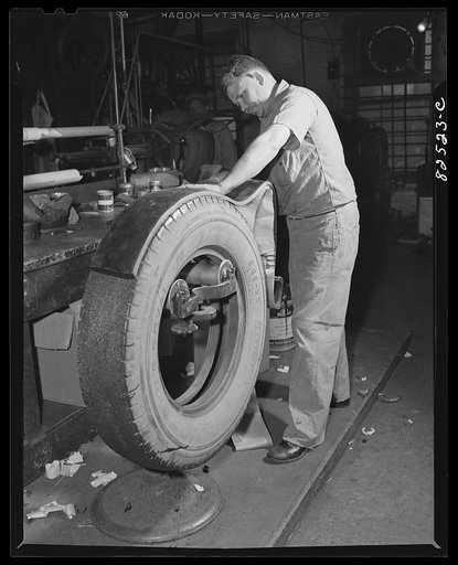Wahington, D.C. Washington tire store. Gluing the recap on a tire