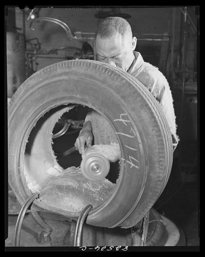 Washington, D.C. Washington tire store. Buffing the lining of a tire before vulcanizing on a patch