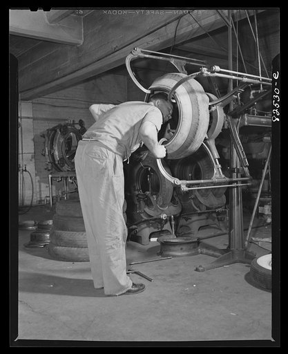 Washington, D.C. Washington tire store. Inspecting the casing of a tire prior to vulcanizing tear