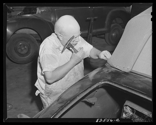 Arlington, Virginia. Auto refinishing plant. Tacking down new top on an old car