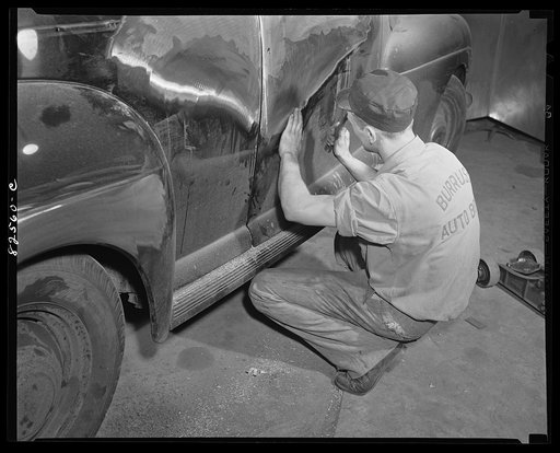 Arlington, Virginia. Auto refinishing plant. Beating dents out of a car body