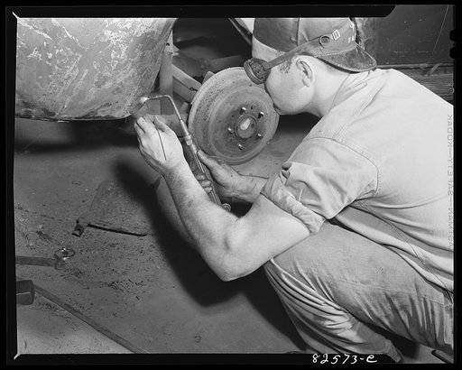 Arlington, Virginia. Auto body work plant. Welding a torn fender
