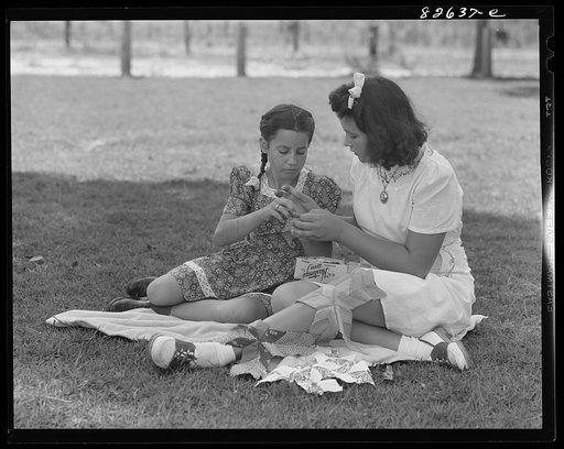 Escambia Farms, Florida. Elena McLelland giving her sister, Kitty, a sewing lesson on the family lawn on a Sunday