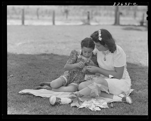Untitled photo, possibly related to: Escambia Farms, Florida. Elena McLelland giving her sister, Kitty, a sewing lesson on the family lawn on a Sunday