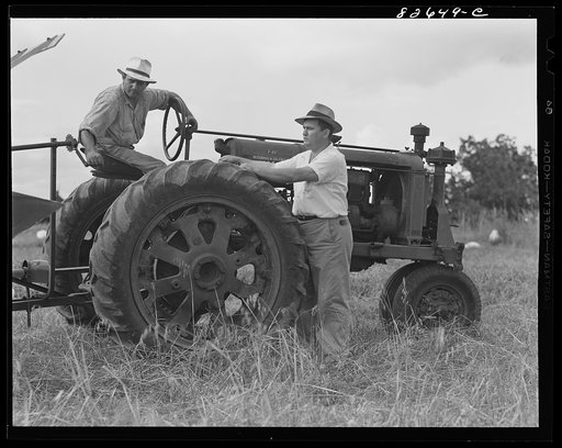 Escambia Farms, Florida. Mr. Hudson, Escambia Farms supervisor, talks things over with operator of cooperatively-owned tractor
