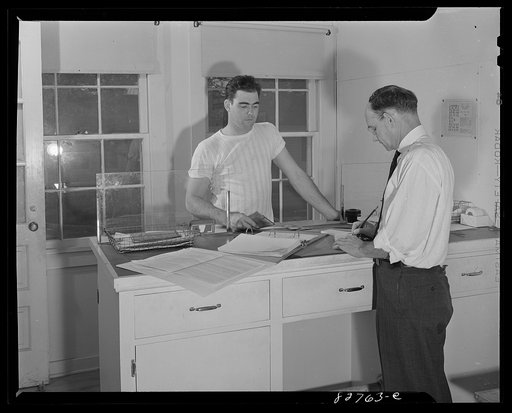 Childersburg, Alabama. Cousa Court defense housing project. Mr. Smith paying his rent
