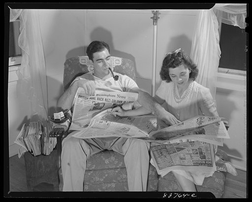 Childersburg, Alabama. Cousa Court defense housing project. Mr. Smith and his wife, both defense workers in the Dupont powder plant, follow the course of the war through the local paper