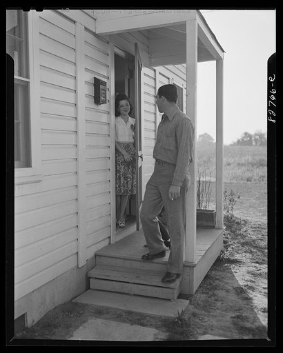 Childersburg, Alabama. Cousa Court defense housing project. Mr. Smith leaves for the early morning shift in the chemical division of the Dupont powder company. His wife will leave "as soon as she does the dishes" for her work as secretary in the plant office