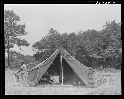 Untitled photo, possibly related to: Bridgeton, New Jersey. FSA (Farm Security Administration) agricultural workers' camp. Migrants filling ticks with straw to serve as mattresses