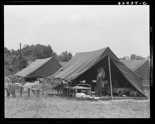 Untitled photo, possibly related to: Bridgeton, New Jersey. FSA (Farm Security Administration) agricultural workers' camp. Migrants filling ticks with straw to serve as mattresses