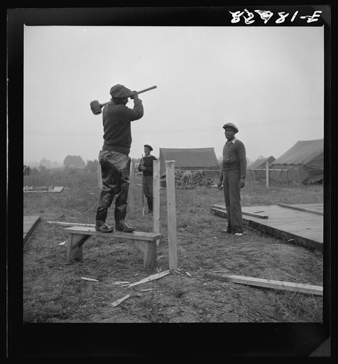 Bridgeton, New Jersey. FSA (Farm Security Administration) agricultural workers' camp. Driving tent stakes