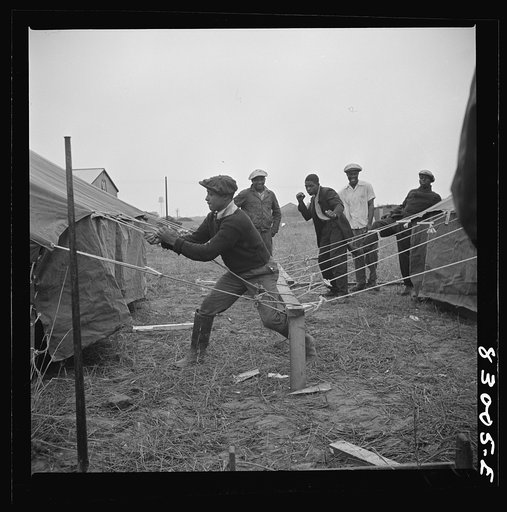 Untitled photo, possibly related to: Bridgeton, New Jersey. FSA (Farm Security Administration) agricultural workers' camp. Setting up tents