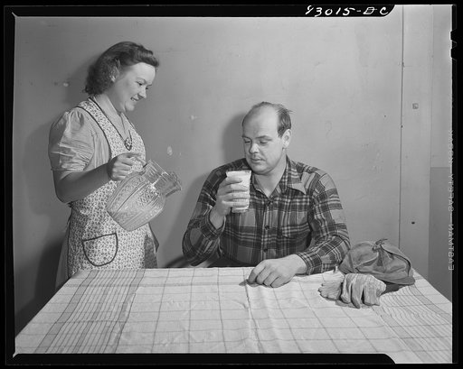 Untitled photo, possibly related to: Bridgeton, New Jersey. Seabrook Farm. Man drinking milk
