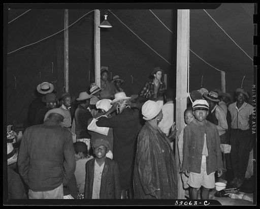 Untitled photo, possibly related to: Bridgeton, N.J. FSA (Farm Security Administration) agricultural workers' camp. The newcomers were led into the recreation tent, where amid their damp bundles they waited for daylight