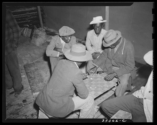 Bridgeton, New Jersey. FSA (Farm Security Administration) agricultural workers' camp. Bottletop checkers is a favorite diversion in the big recreation tent