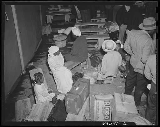 Bridgeton, New Jersey. FSA (Farm Security Administration) agricultural workers' camp. In the pouring rain, the newly arrived migrants find shelter under the recreation tent