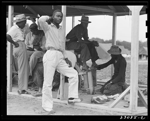 Bridgeton, New Jersey. FSA (Farm Security Administration) agricultural workers' camp. Camp bootblack stand on a Sunday morning