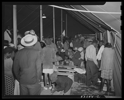 Untitled photo, possibly related to: Bridgeton, New Jersey. FSA (Farm Security Administration) agricultural workers' camp. In the pouring rain, the newly arrived migrants find shelter under the recreation tent