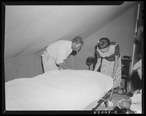 Bridgeton, New Jersey. FSA (Farm Security Administration) agricultural workers' camp. Migrant making up straw mattress