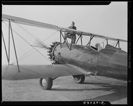 Untitled photo, possibly related to: Bridgeton, New Jersey. Seabrook Farm. Loading gasoline into a dusting plane. Dust or insecticide is spread by low flying planes onto crops to control various insect pests