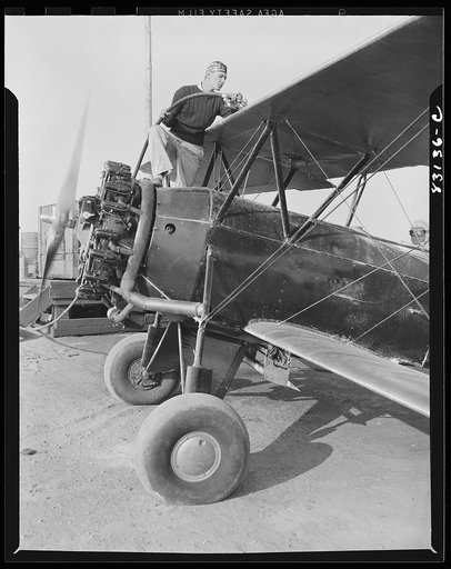 Untitled photo, possibly related to: Bridgeton, New Jersey. Seabrook Farm. Loading gasoline into a dusting plane. Dust or insecticide is spread by low flying planes onto crops to control various insect pests