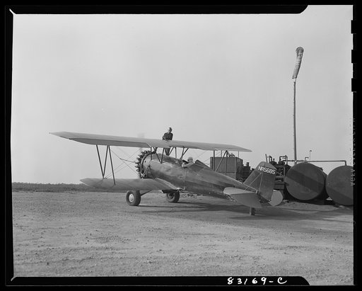 Bridgeton, New Jersey. Seabrook Farm. Plane loading gas at dawn before dusting the field. Dust or insecticide is spread by low flying planes onto crops to control various insect pests