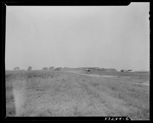 Untitled photo, possibly related to: Bridgeton, New Jersey. Seabrook Farm. Dusting by airplane. Dust or insecticide is spread by low flying planes onto crops to control various insect pest