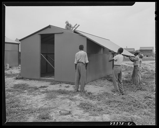 Untitled photo, possibly related to: Bridgeton, New Jersey. FSA (Farm Security Administration) agricultural workers' camp. Putting up a prefabricated house made from materials not affected by wartime shortages