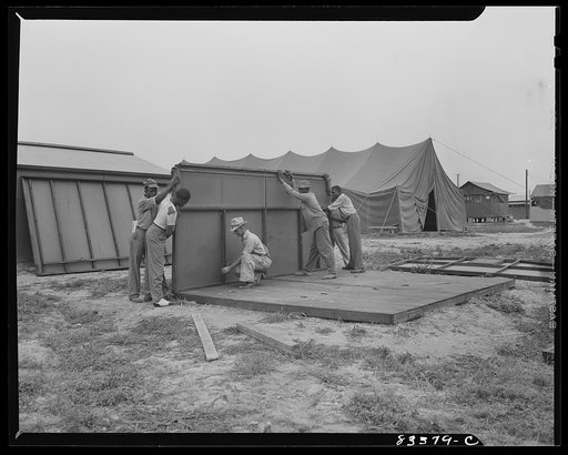 Bridgeton, New Jersey. FSA (Farm Security Administration) agricultural workers' camp. Putting up a prefabricated house made from materials not affected by wartime shortages
