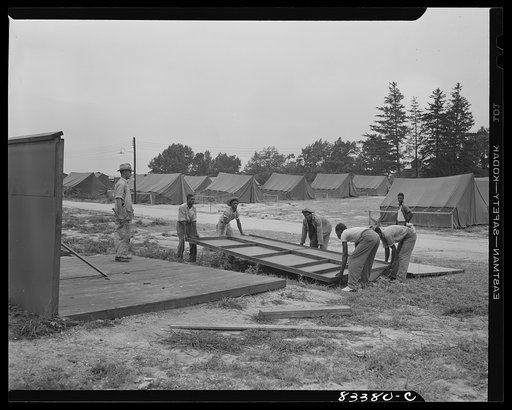 Bridgeton, New Jersey. FSA (Farm Security Administration) agricultural workers' camp. Putting up a prefabricated house made from materials not affected by wartime shortages