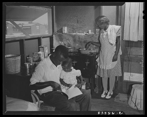 Untitled photo, possibly related to: Bridgeton, New Jersey. FSA (Farm Security Administration) agricultural workers' camp. Councilman at home with his family