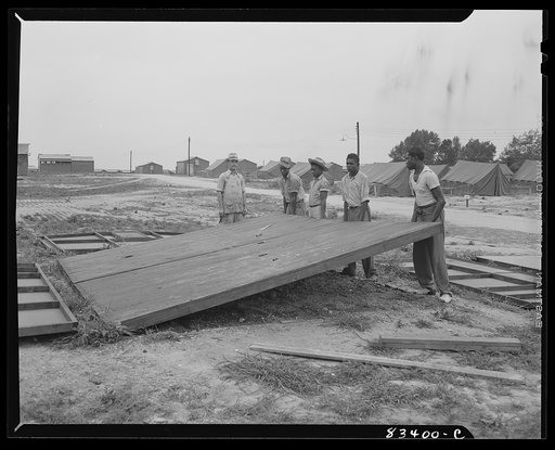 Bridgeton, New Jersey. FSA (Farm Security Administration) agricultural workers' camp. Putting up a prefabricated house made from materials not affected by wartime shortages