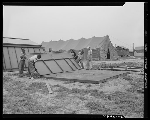 Bridgeton, New Jersey. FSA (Farm Security Administration) agricultural workers' camp. Putting up a prefabricated house made from materials not affected by wartime shortages