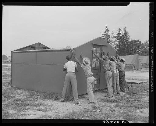 Bridgeton, New Jersey. FSA (Farm Security Administration) agricultural workers' camp. Putting up a prefabricated house made from materials not affected by wartime shortages