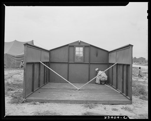 Bridgeton, New Jersey. FSA (Farm Security Administration) agricultural workers' camp. Putting up a prefabricated house made from materials not affected by wartime shortages