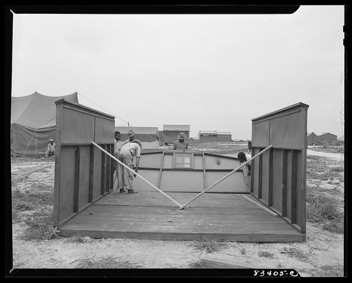 Bridgeton, New Jersey. FSA (Farm Security Administration) agricultural workers' camp. Putting up a prefabricated house made from materials not affected by wartime shortages