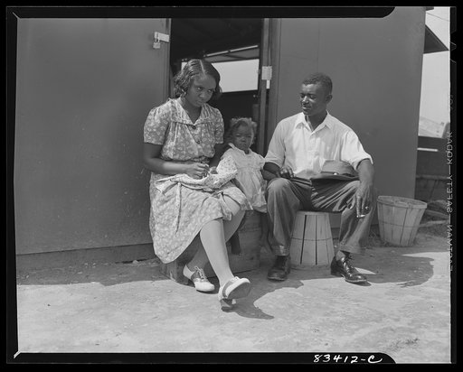 Untitled photo, possibly related to: Bridgeton, New Jersey. FSA (Farm Security Administration) agricultural workers' camp. Councilman and family on the stoop of their house