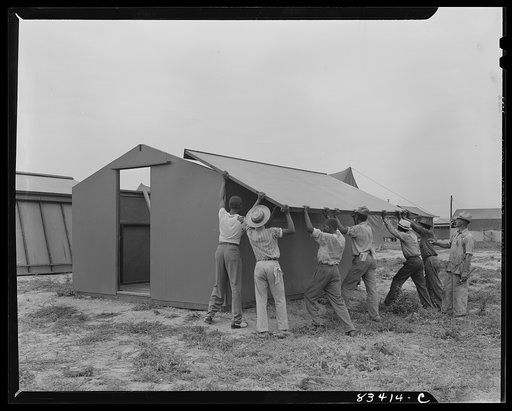 Untitled photo, possibly related to: Bridgeton, New Jersey. FSA (Farm Security Administration) agricultural workers' camp. Putting up a prefabricated house made from materials not affected by wartime shortages