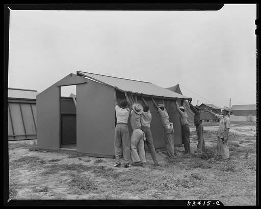 Bridgeton, New Jersey. FSA (Farm Security Administration) agricultural workers' camp. Putting up a prefabricated house made from materials not affected by wartime shortages