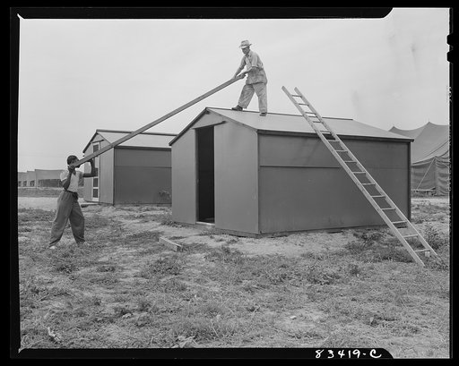 Untitled photo, possibly related to: Bridgeton, New Jersey. FSA (Farm Security Administration) agricultural workers' camp. Putting up a prefabricated house made from materials not affected by wartime shortages