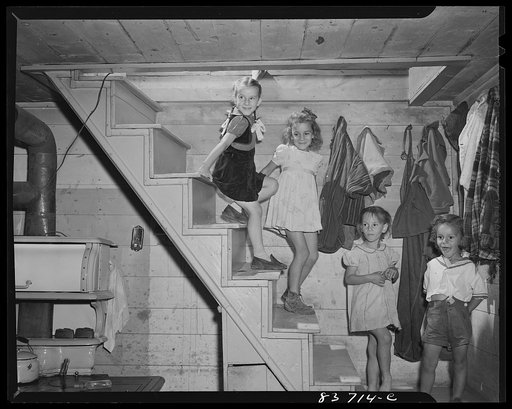 Fort Kent, Maine (vicinity). The Daigle children coming down from the second floor of their home which, as is the downstairs, is one big room. The entire family sleeps in the big upstairs room