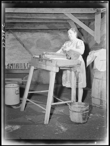 Fort Kent, Maine (vicinity). Mrs. [Leonard] Gagnon wringing water out of butter after salting