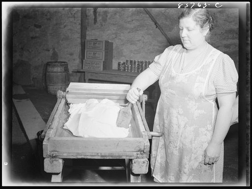Fort Kent, Maine (vicinity). Mrs. Gagnon wringing water out of butter after salting
