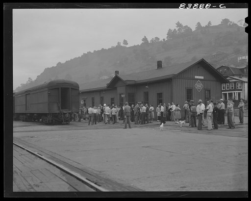 Richwood, West Virginia. Boys and girls, single men and families, waiting to board special train which will carry them to Batavia, New York where they will help bring in the harvest