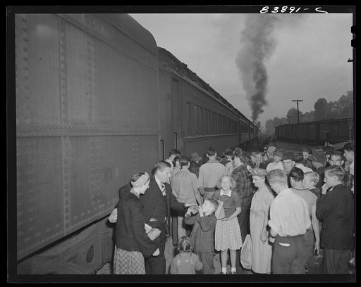 Richwood, West Virginia. Boys and girls, single men and families, waiting to board special train which will carry them to Batavia, New York where they will help bring in the harvest