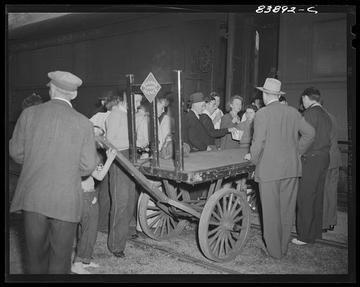 Richwood, West Virginia. Men recruited for harvest work in New York state having their tickets checked before boarding train in Richwood