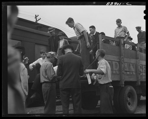 Summersville, West Virginia. Boys and men arriving at train which will carry them to New York state to work in the harvest