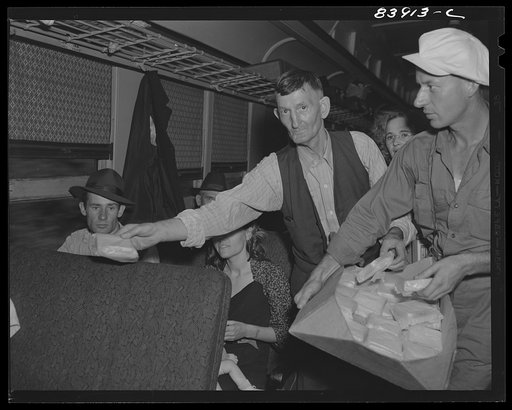 Untitled photo, possibly related to: Bryant Friend helped distribute free sandwiches to the migratory workers en route to help with the harvest in upper New York state